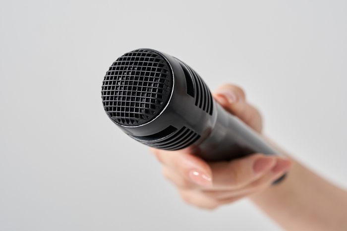 Woman's hand with wireless microphone