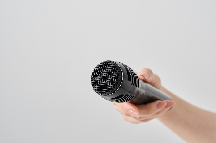 Woman's hand with wireless microphone