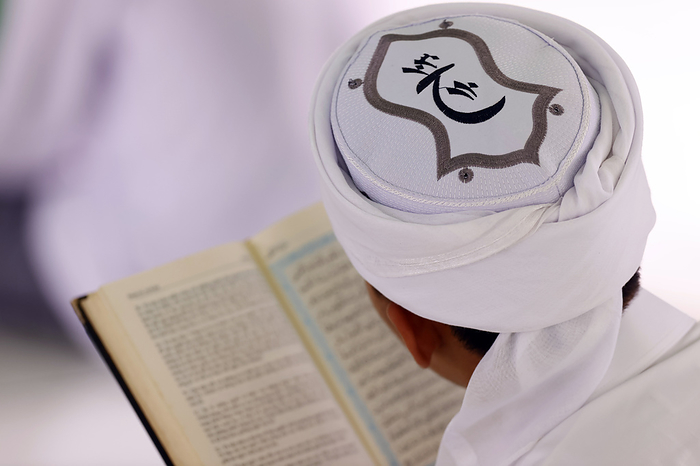 Jamiul Azhar mosque. Muslim man reading an Arabic Holy Quran  Koran . Vietnam. Muslim man reading an Arabic Holy Quran  Koran , Jamiul Azhar mosque, Vietnam, Indochina, Southeast Asia, Asia, by Godong
