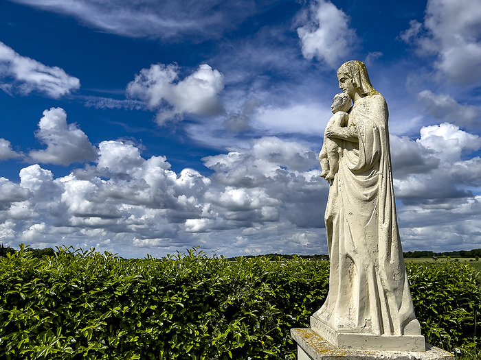 Virgin and child statue, in a Normandy landscape, Eure, France Virgin and Child statue, in a Normandy landscape, Eure, Normandy, France, Europe, by Godong