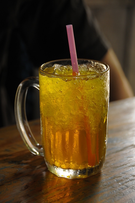A glass of chrysanthemum ice tea in a street tea shop in Bangkok, Thailand A glass of chrysanthemum iced tea in a street tea shop in Bangkok, Thailand, Southeast Asia, Asia, by Michael Szafarczyk