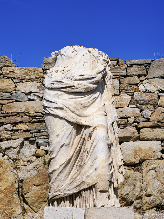 Headless Statue at the Temple of Isis, Delos Archaeological Site, Delos Island, Cyclades, Greece Headless Statue at the Temple of Isis, Delos Archaeological Site, UNESCO World Heritage Site, Delos Island, Cyclades, Greek Islands, Greece, Europe, by Karol Kozlowski