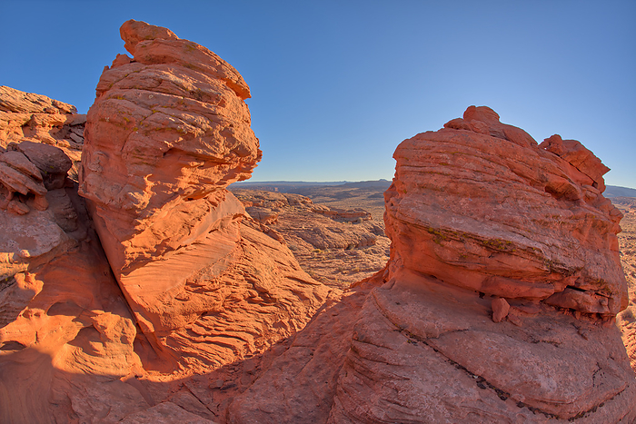 A pair of sandstone hoodoos at Ferry Swale in the Glen Canyon Recreation Area near Page Arizona. A pair of sandstone hoodoos at Ferry Swale in the Glen Canyon Recreation Area near Page, Arizona, United States of America, North America, by Steven Love