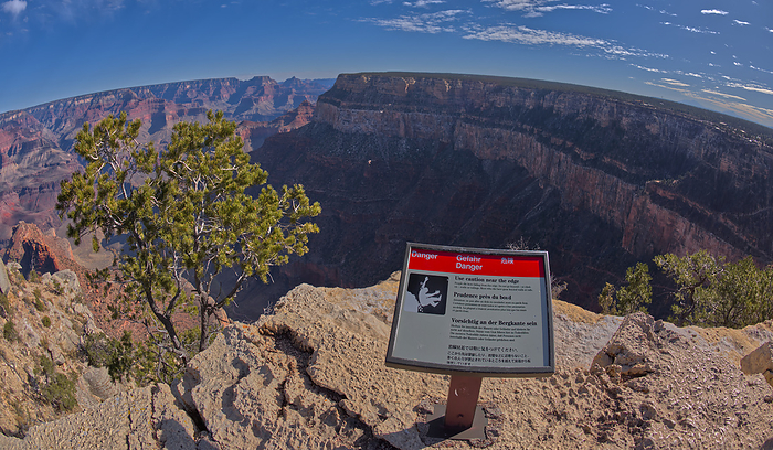 A sign in different languages warning of a dangerous cliff at the West Vista of the Trailview Overlook along the Hermit Road rim trail. A sign in different languages warning of a dangerous cliff at the West Vista of the Trailview Overlook along the Hermit Road rim trail, Grand Canyon, UNESCO World Heritage Site, Arizona, United States of America, North America, by Steven Love