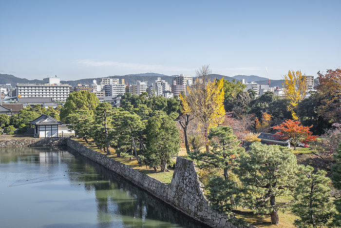 Nij  Castle garden and moat in autumn with the modern city in the background, Kyoto, Japan Nijo Castle garden and moat in autumn with the modern city in the background, Kyoto, Honshu, Japan, Asia, by Francesco Fanti