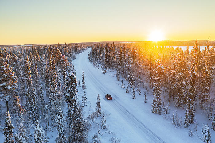 Car travels the icy and empty road crossing the boreal snowy forest at sunrise, Swedish Lapland, Sweden, Scandinavia, Europe Car travels the icy and empty road crossing the boreal snowy forest at sunrise, Swedish Lapland, Sweden, Scandinavia, Europe, by Paolo Graziosi