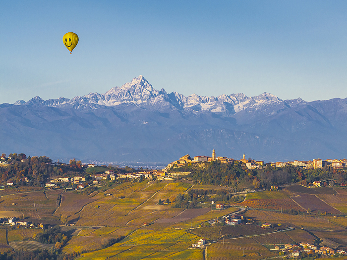 one hot air baloon flight over La Morra village with a Monviso mountain in background, during an autumn day, Cuneo province, Piedmont, Italy, Europe Hot air balloon flight over La Morra village with a Monviso Mountain in the background, on an autumn day, Cuneo province, Piedmont, Italy, Europe, by carlo alberto conti