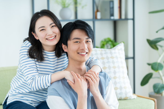 A young Japanese couple relaxing in the living room (People)