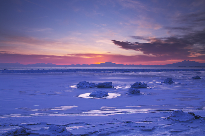 Morning drift ice on the Sea of Okhotsk with Mt. Haibetsu and Mt. Shari (right), Hokkaido