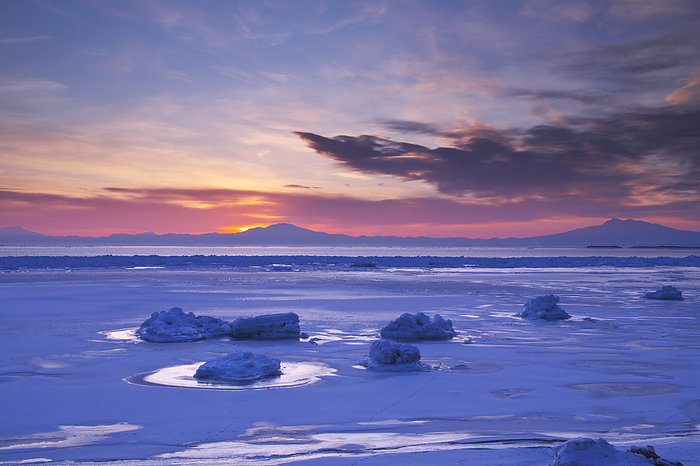Morning drift ice on the Sea of Okhotsk with Mt. Haibetsu and Mt. Shari (right), Hokkaido