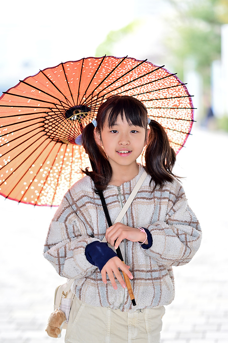 A girl holding a Japanese umbrella