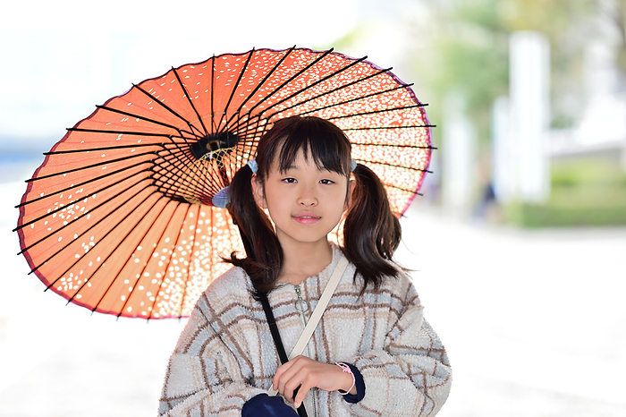 A girl holding a Japanese umbrella