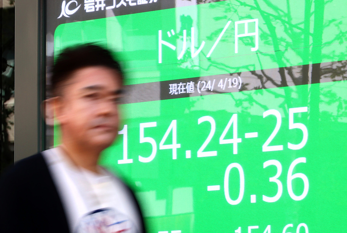 Jaoan s share prices dropped at the Tokyo Stock Exchange April 19, 2024, Tokyo, Japan   A pedestrian passes before a foreign exchange quotation board in Tokyo on Friday, April 19, 2024. Japanese yen was traded at 145 yen level against US dollar at the Tokyo forex market.     photo by Yoshio Tsunoda AFLO 