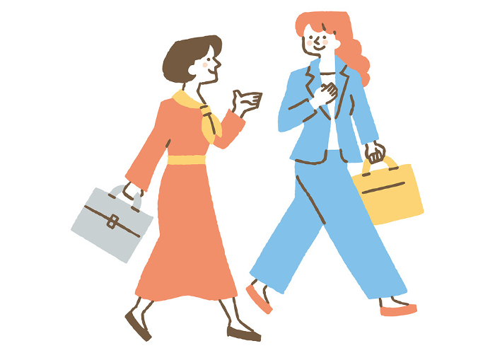 Two businesswomen walking while talking_Color