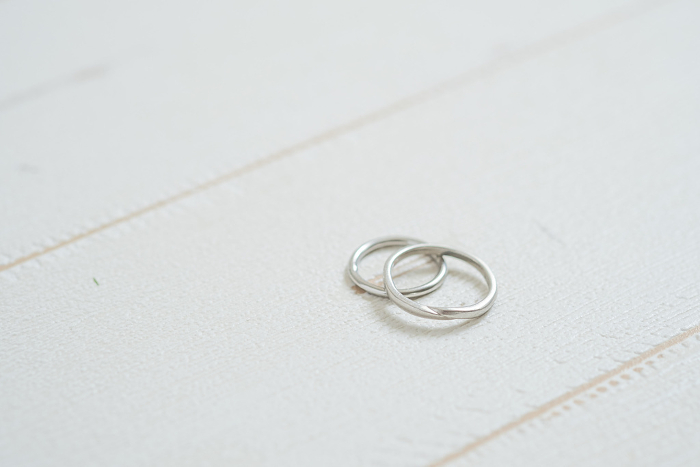 White wood background with wedding rings