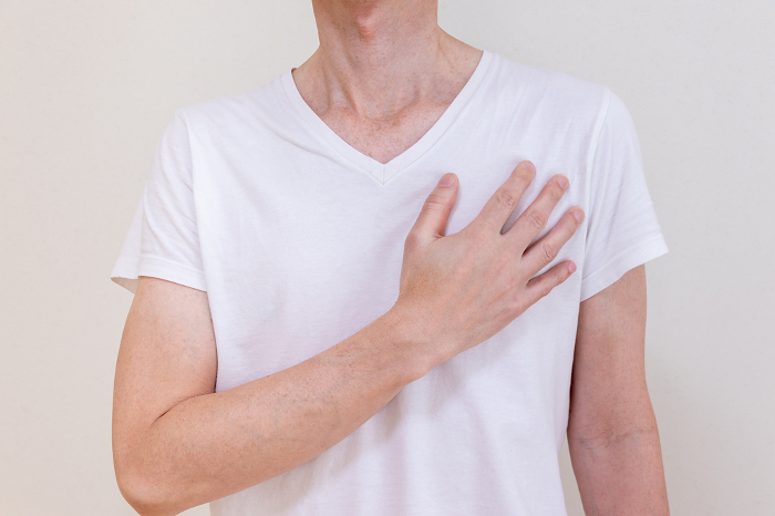 Man with hand on left chest