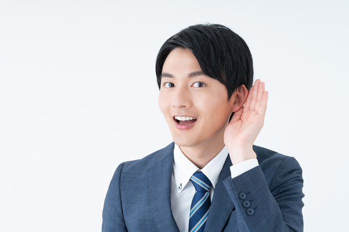 Young Japanese businessman listening (People)