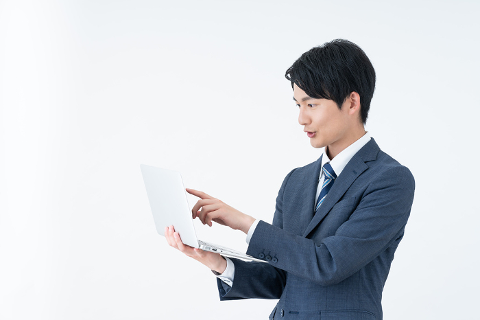 Young Japanese businessman with computer (People)
