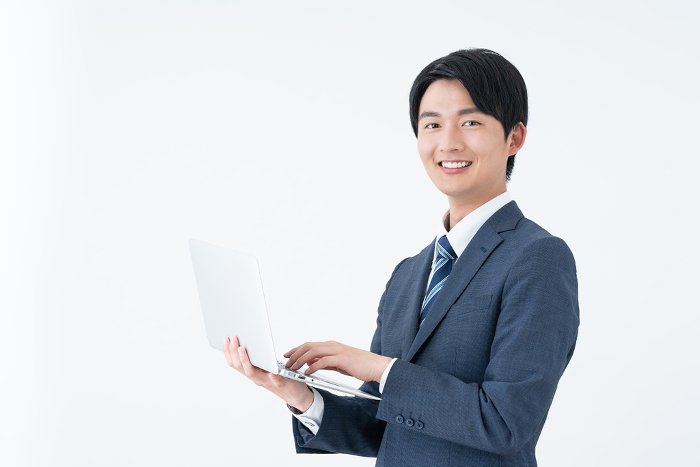 Young Japanese businessman with computer (People)
