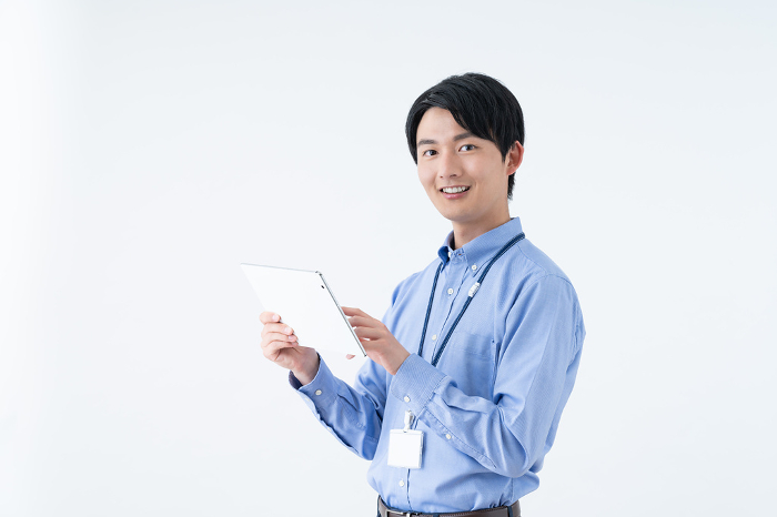 Young Japanese engineer using a tablet (Male / People)