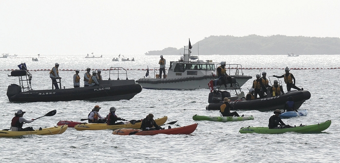 Construction of the new U.S. military base at Henoko Buoys to be set up for undersea survey Floats and other equipment are being installed along the Henoko coastline in Nago City, Okinawa Prefecture, at 9:20 a.m. on August 15, 2014, as Coast Guard rubber boats and other vessels warn of boats  foreground  that oppose the relocation of the Futenma Air Station  Ginowan City, Okinawa Prefecture . On the morning of the 15th, buoys were being installed along the Henoko coastline in Nago City, Okinawa Prefecture, where the U.S. Futenma Air Station  Ginowan City, Okinawa Prefecture  will be relocated. All work is expected to be completed by the end of the day.  The work began on the 14th, and on the 15th, from around 8:00 a.m., about 10 vessels from the Okinawa Defense Bureau went out to the water area to install floats that connect the buoys.  The Japan Coast Guard was on the lookout with rubber boats and patrol boats on the same day. On one occasion, a canoe belonging to an anti relocation group was returned to the wharf when it tried to approach the work area.