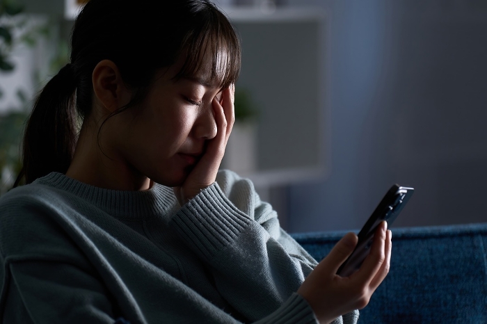 Japanese woman depressed after looking at her smartphone (People)