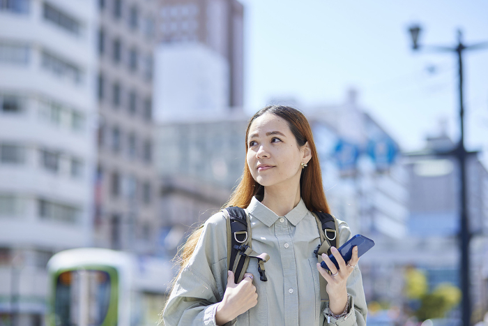 Female inbound traveler with smartphone