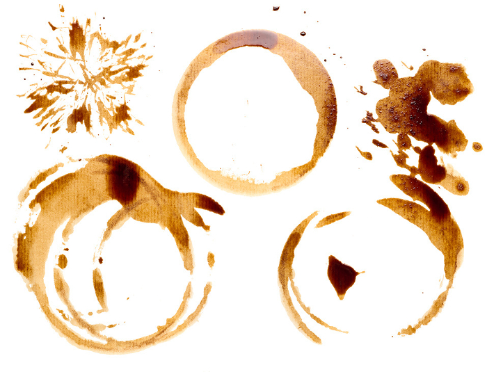 Spilled coffee with drops and splashes, round imprints from a cup on an isolated background Spilled coffee with drops and splashes, round imprints from a cup on an isolated background