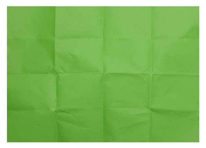 Green folded sheet of paper on isolated background Green folded sheet of paper on isolated background