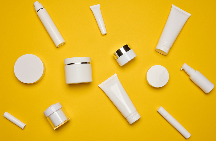 Various types of white plastic packaging, bottle, jar, tube on a yellow background. Container for cosmetics, top view Various types of white plastic packaging, bottle, jar, tube on a yellow background. Container for cosmetics, top view