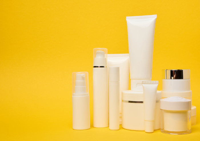 Various types of white plastic packaging, bottle, jar, tube on a yellow background. Container for cosmetics, copy space Various types of white plastic packaging, bottle, jar, tube on a yellow background. Container for cosmetics, copy space
