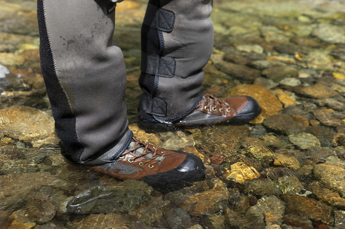 Angler's feet walking in the river