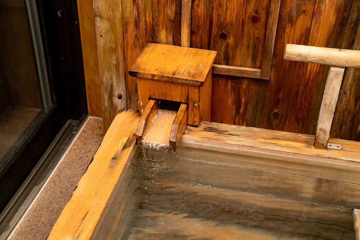 Photo of the natural hot spring bath in the guest room with hot spring. Image of the hot spring.