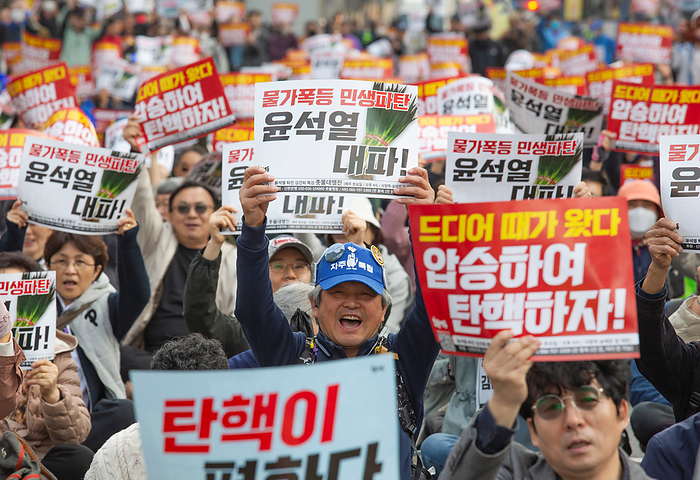 South Koreans demand the impeachment of President Yoon Suk Yeol at a rally in Seoul Protest demanding the impeachment of President Yoon Suk Yeol, Apr 6, 2024 : People attend a rally demanding the impeachment of President Yoon Suk Yeol in Seoul, South Korea. The photos of green onions on pickets make a parody of Yoon who aroused anger by finding the price tag of 875 won   0.65  for a bunch of green onions a  reasonable price  at a grocery store in March. The 875 won   0.65  was a temporary discount price offered due to a government subsidy and the average retail prices of green onions was about 3,000 to 4,000 won   2.2 to 2.9  for weeks, which was some of the highest levels over the years. The prices of foods and daily necessities are surging rapidly in Korea, local media reported. Pickets read, Sharp price rise. Bankrupt livelihoods of the public. Let s put Yoon Suk Yeol to rout   and  It s time for us to vote. Let s win the April 10 Parliament Election by a landslide to impeach Yoon  .  Photo by Lee Jae Won AFLO 