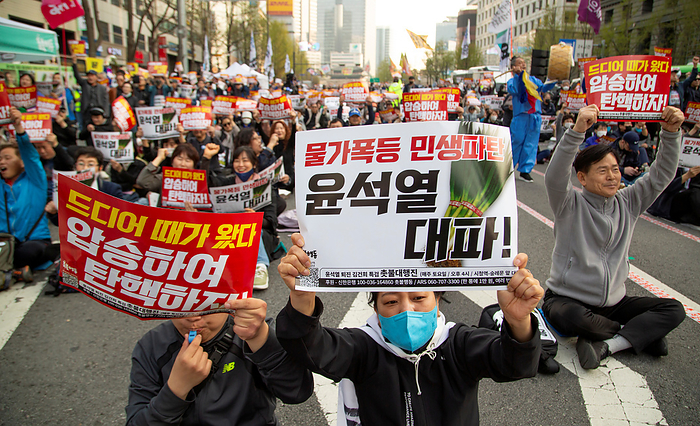 South Koreans demand the impeachment of President Yoon Suk Yeol at a rally in Seoul Protest demanding the impeachment of President Yoon Suk Yeol, Apr 6, 2024 : People attend a rally demanding the impeachment of President Yoon Suk Yeol in Seoul, South Korea. The photos of green onions on pickets make a parody of Yoon who aroused anger by finding the price tag of 875 won   0.65  for a bunch of green onions a  reasonable price  at a grocery store in March. The 875 won   0.65  was a temporary discount price offered due to a government subsidy and the average retail prices of green onions was about 3,000 to 4,000 won   2.2 to 2.9  for weeks, which was some of the highest levels over the years. The prices of foods and daily necessities are surging rapidly in Korea, local media reported. Pickets read, Sharp price rise. Bankrupt livelihoods of the public. Let s put Yoon Suk Yeol to rout   and  It s time for us to vote. Let s win the April 10 Parliament Election by a landslide to impeach Yoon  .  Photo by Lee Jae Won AFLO 
