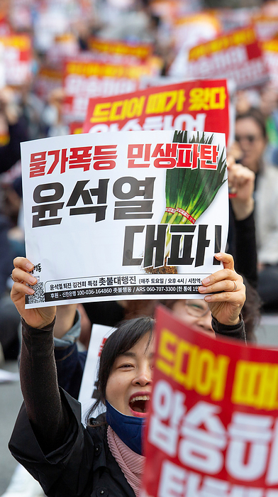 South Koreans demand the impeachment of President Yoon Suk Yeol at a rally in Seoul Protest demanding the impeachment of President Yoon Suk Yeol, Apr 6, 2024 : People attend a rally demanding the impeachment of President Yoon Suk Yeol in Seoul, South Korea. The photo of green onions on a picket makes a parody of Yoon who aroused anger by finding the price tag of 875 won   0.65  for a bunch of green onions a  reasonable price  at a grocery store in March. The 875 won   0.65  was a temporary discount price offered due to a government subsidy and the average retail prices of green onions was about 3,000 to 4,000 won   2.2 to 2.9  for weeks, which was some of the highest levels over the years. The prices of foods and daily necessities are surging rapidly in Korea, local media reported. Pickets read, Sharp price rise. Bankrupt livelihoods of the public. Let s put Yoon Suk Yeol to rout   and  It s time for us to vote. Let s win the April 10 Parliament Election by a landslide to impeach Yoon  .  Photo by Lee Jae Won AFLO 