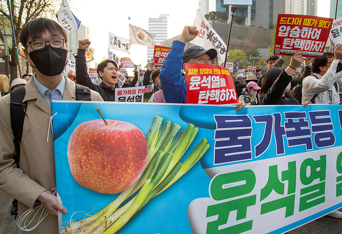 South Koreans demand the impeachment of President Yoon Suk Yeol at a rally in Seoul Protest demanding the impeachment of President Yoon Suk Yeol, Apr 6, 2024 : People attend a rally demanding the impeachment of President Yoon Suk Yeol in Seoul, South Korea. The photo of green onions on a placard makes a parody of Yoon who aroused anger by finding the price tag of 875 won   0.65  for a bunch of green onions a  reasonable price  at a grocery store in March. The 875 won   0.65  was a temporary discount price offered due to a government subsidy and the average retail prices of green onions was about 3,000 to 4,000 won   2.2 to 2.9  for weeks, which was some of the highest levels over the years. The prices of foods and daily necessities are surging rapidly in Korea, local media reported. Pickets read, Sharp price rise. Bankrupt livelihoods of the public. Let s put Yoon Suk Yeol to rout   and  It s time for us to vote. Let s win the April 10 Parliament Election by a landslide to impeach Yoon  . The placard reads,  Sharp price rise. Bankrupt livelihoods of the public. Let s put Yoon Suk Yeol to rout  .  Photo by Lee Jae Won AFLO 