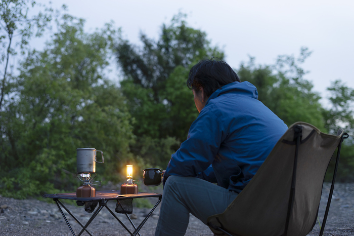 Man enjoying solo camping at sunset