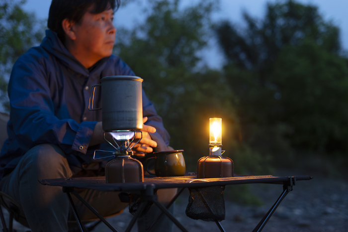 Man enjoying solo camping at sunset
