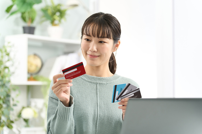Japanese woman choosing a credit card (People)