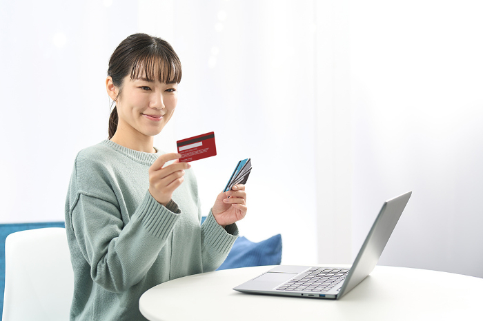 Japanese woman choosing a credit card (People)