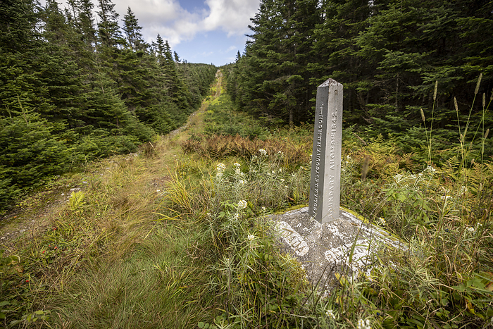 Canada U.S. border Obelisk along international boundary separates USA from Canada Woburn, Qu bec, Canada
