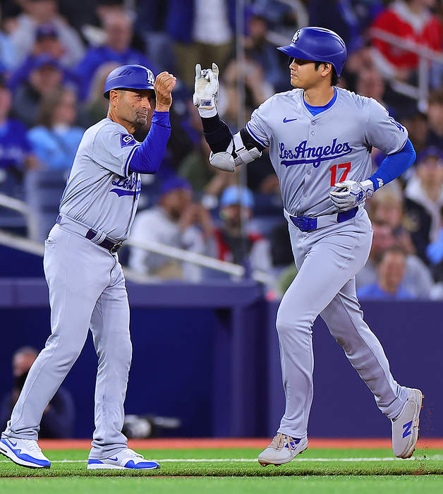 2024 MLB Otani hits No. 7 solo home run  Blue Jays Dodgers Otani poses with Coach Ebel  left  after his first solo shot in the first inning  Photo by Takahiro Mitsuyama .