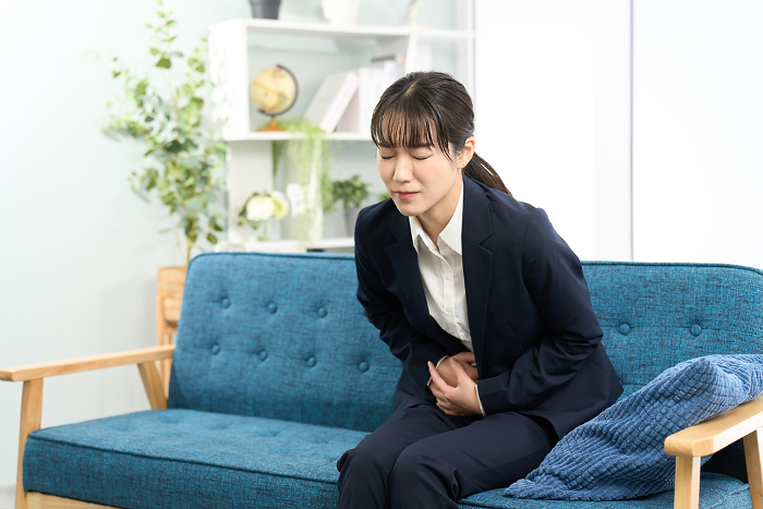A Japanese woman gets a stomach ache before going to work.