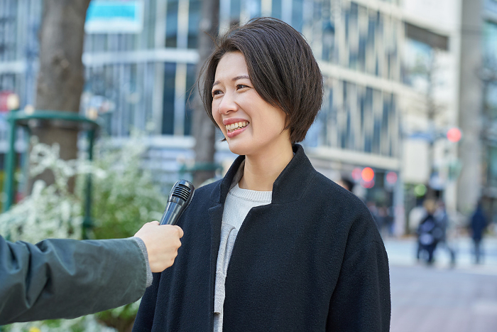 Japanese woman being interviewed on the street (People)