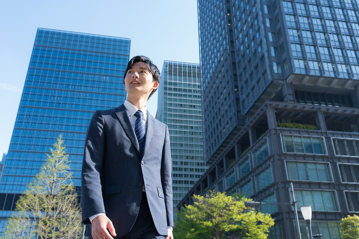 Young Japanese businessman working in an office district (People)