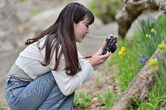 Woman photographing flowers.