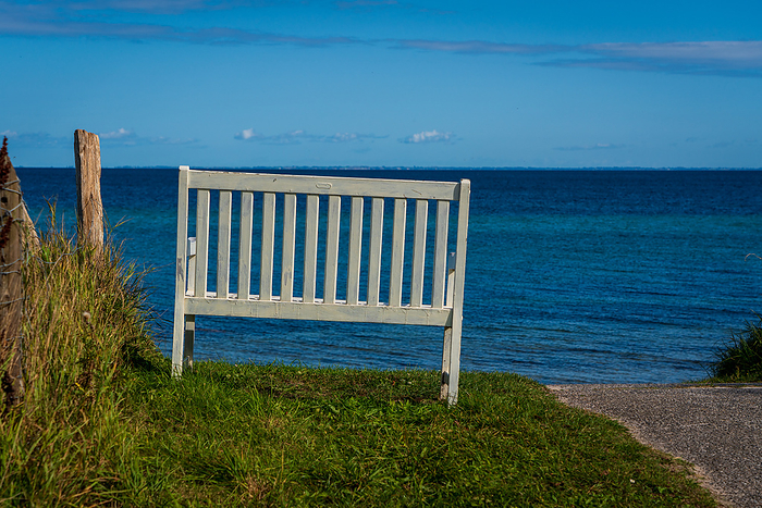 A white bench on the Baltic Sea, Germany. A white bench on the Baltic Sea, Germany., by Zoonar Bernhard Klar