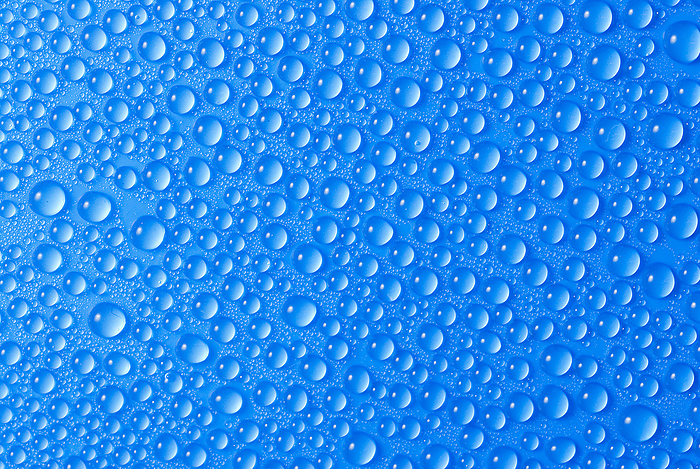 many small blue drops of water on a blue surface many small blue drops of water on a blue surface, by Zoonar Andreas Malli