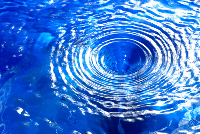 closeup, macro of a small water vortex or swirl, causing circular waves on the surface closeup, macro of a small water vortex or swirl, causing circular waves on the surface, by Zoonar Andreas Malli